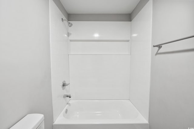 bathroom with shower / bathing tub combination and toilet