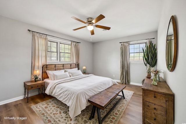 bedroom with baseboards, ceiling fan, and wood finished floors