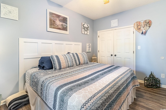 bedroom featuring a closet, baseboards, and dark wood-style floors