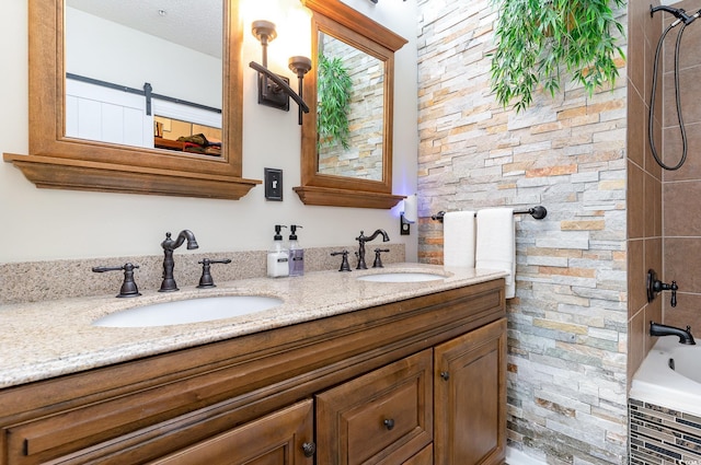 bathroom with double vanity, a sink, and tiled shower / bath combo