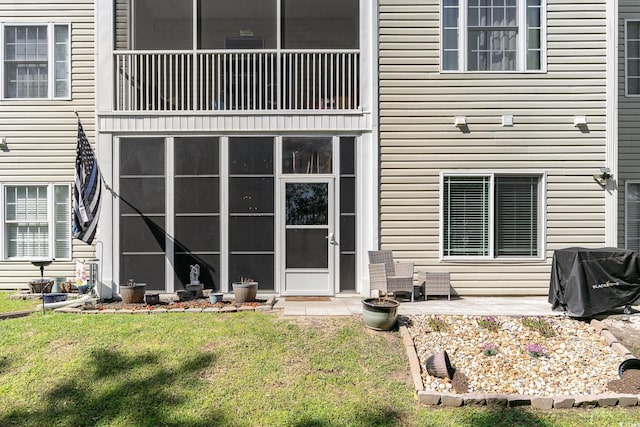 rear view of house with a patio and a yard