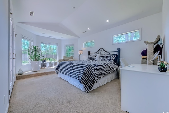 bedroom featuring visible vents, multiple windows, light colored carpet, and lofted ceiling
