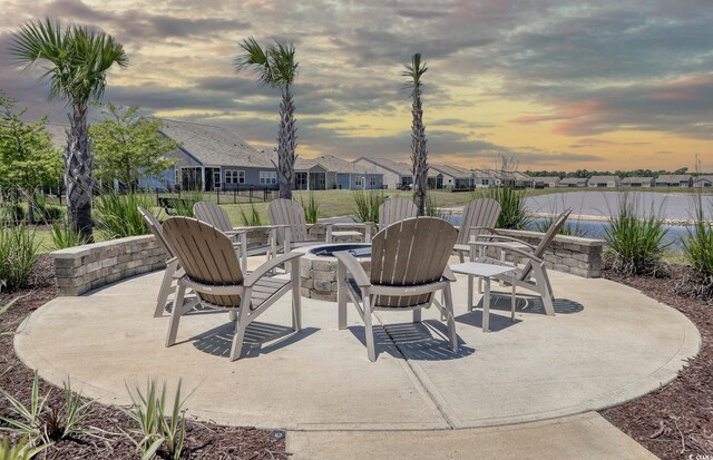 245 Eagle Claw Dr, Calabash, NC 28467 - view of patio featuring a fire pit, a water view, and a residential view