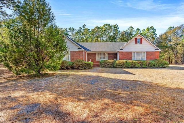 ranch-style home featuring brick siding