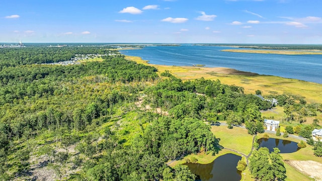 aerial view with a forest view and a water view
