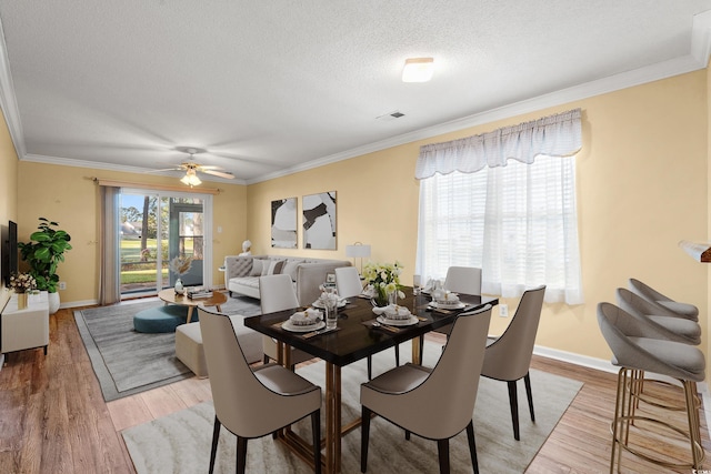 820 Fairway Dr Unit 1506Hh, Longs, SC 29568 - dining area featuring light wood-style flooring, ornamental molding, baseboards, a textured ceiling, and ceiling fan