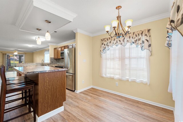 820 Fairway Dr Unit 1506Hh, Longs, SC 29568 - kitchen featuring appliances with stainless steel finishes, light wood-type flooring, a breakfast bar area, baseboards, and ornamental molding
