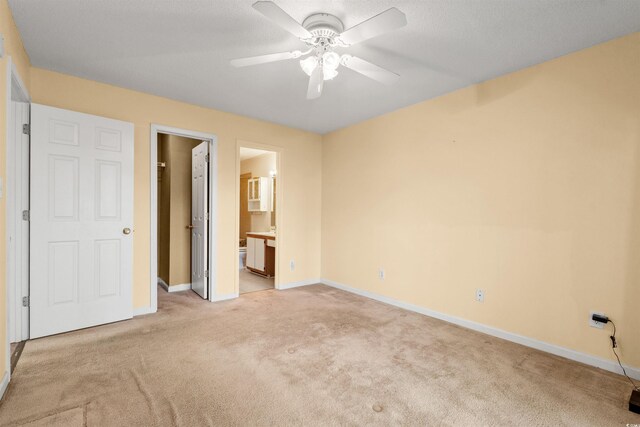 820 Fairway Dr Unit 1506Hh, Longs, SC 29568 - unfurnished bedroom with light carpet, baseboards, ensuite bathroom, and a ceiling fan
