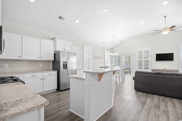 kitchen featuring stainless steel fridge, vaulted ceiling, ceiling fan, open floor plan, and dark wood-type flooring