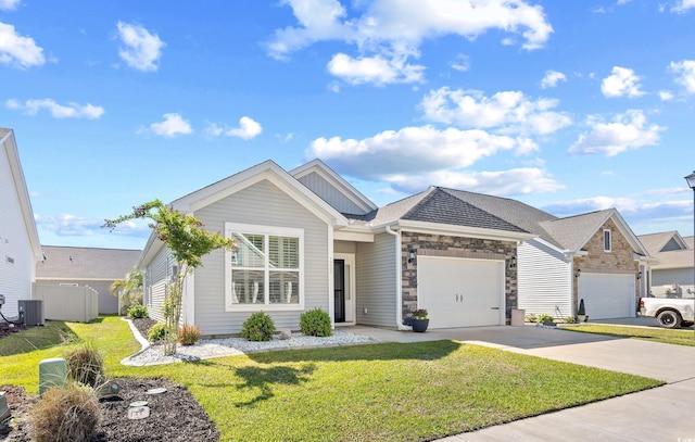 view of front facade featuring central air condition unit, a garage, a front lawn, and driveway