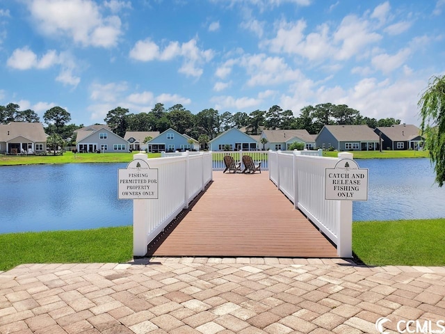 dock with a residential view and a water view