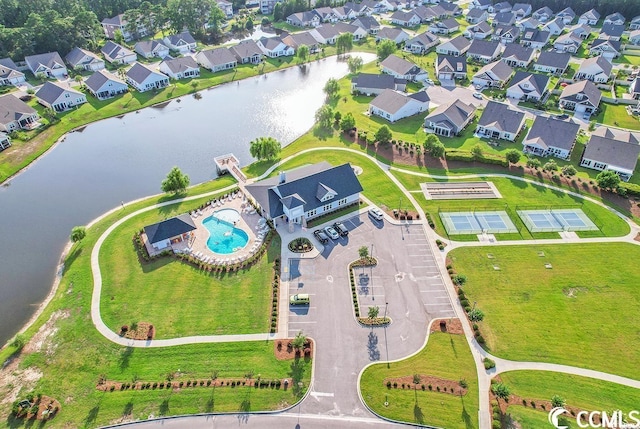 aerial view of residential area with a pool area and a nearby body of water
