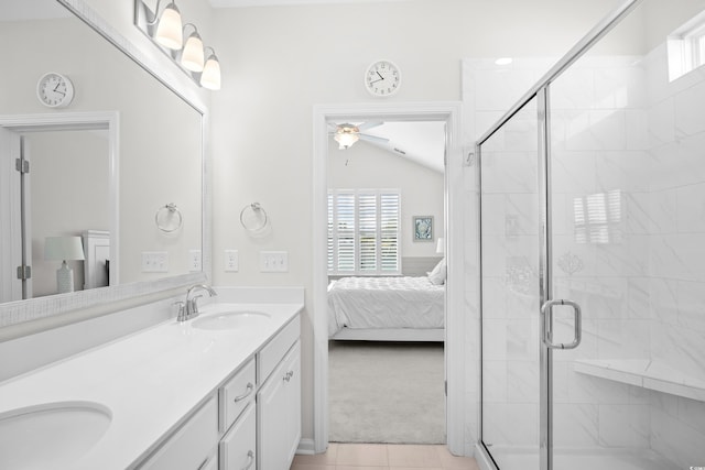 ensuite bathroom with plenty of natural light, a ceiling fan, vaulted ceiling, and a shower stall