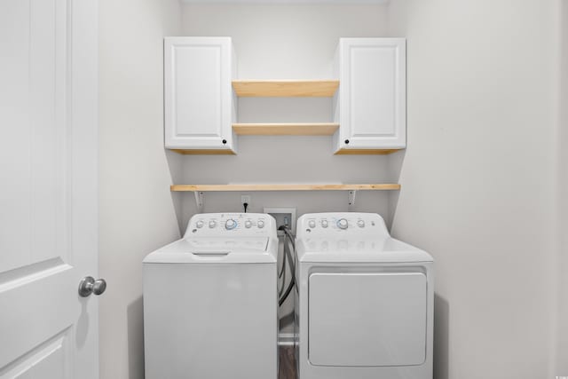 laundry room with washer and dryer and cabinet space