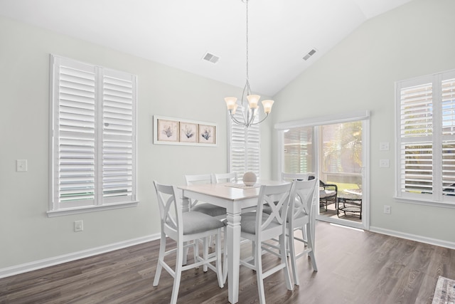 dining space featuring a chandelier, vaulted ceiling, wood finished floors, and healthy amount of natural light