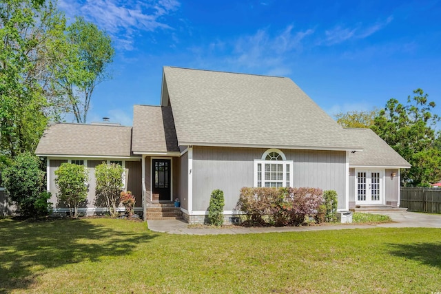 view of front of property with french doors, a front lawn, fence, and roof with shingles