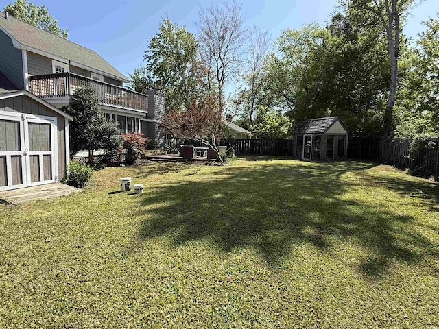 view of yard with an outbuilding, a shed, and a fenced backyard
