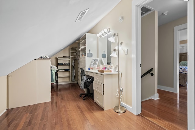 office with wood finished floors and lofted ceiling