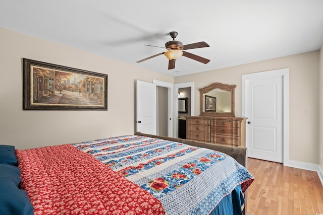 bedroom featuring baseboards, light wood-type flooring, and a ceiling fan