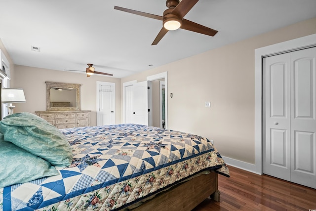 bedroom featuring visible vents, baseboards, a closet, ceiling fan, and wood finished floors