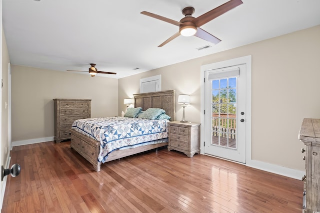 bedroom with visible vents, access to exterior, wood-type flooring, and baseboards