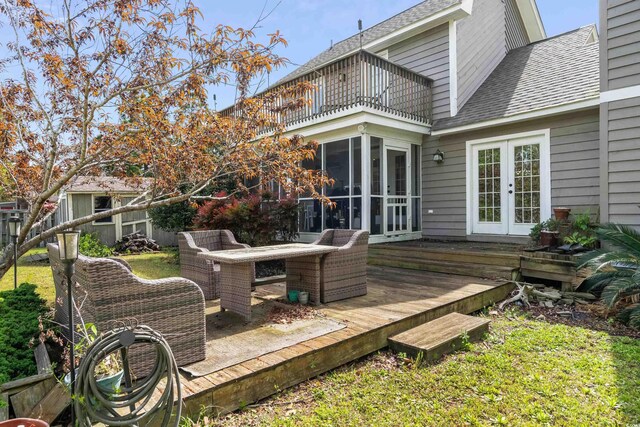 wooden deck featuring outdoor dining area and french doors