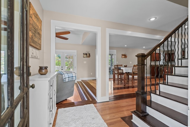 entrance foyer featuring french doors, ceiling fan, plenty of natural light, and stairs
