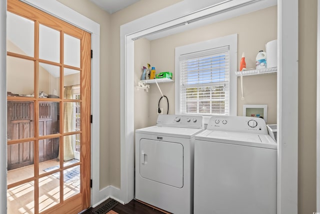 washroom with independent washer and dryer and laundry area