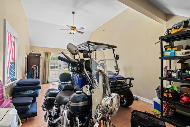 interior space featuring ceiling fan, wood finished floors, and lofted ceiling