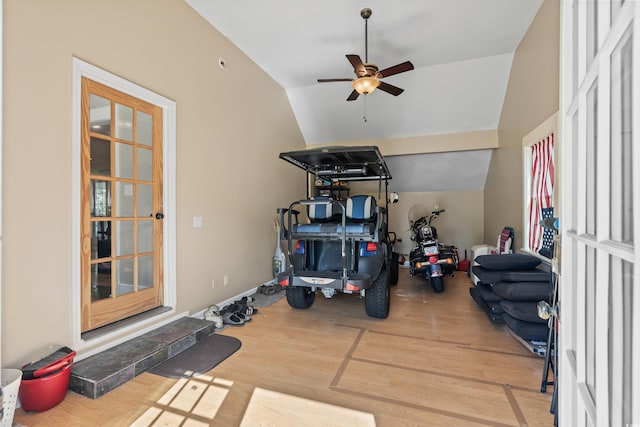 exercise area with wood finished floors, a ceiling fan, and vaulted ceiling