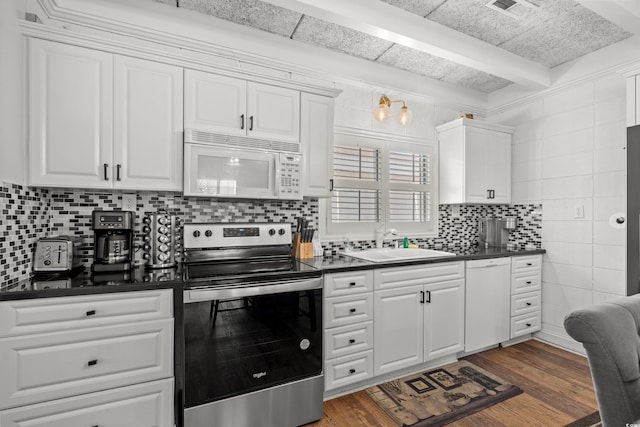 kitchen featuring a sink, white appliances, white cabinets, and dark countertops