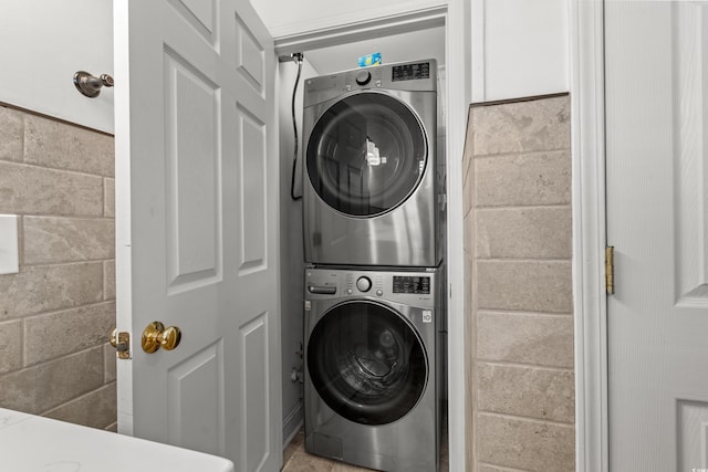 washroom with laundry area and stacked washer and dryer
