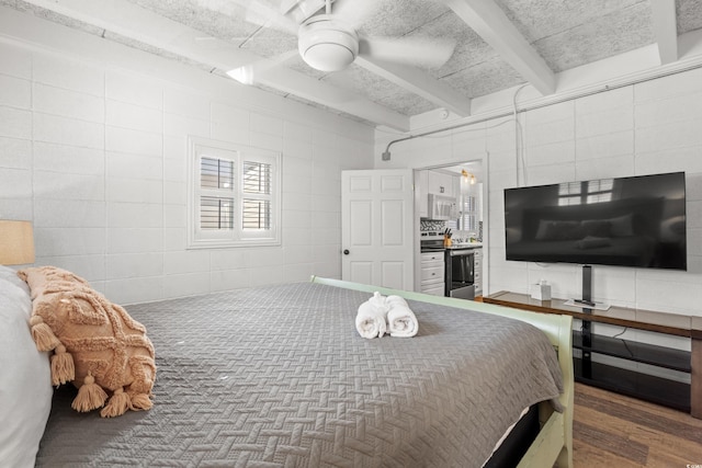 bedroom with wood finished floors, beamed ceiling, and ceiling fan