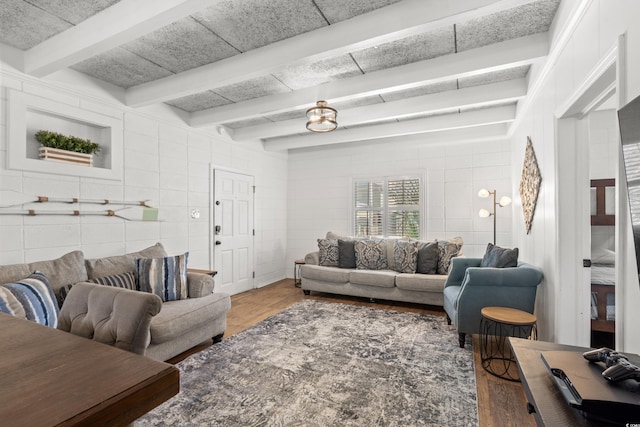 living area with tile walls, beamed ceiling, and wood finished floors