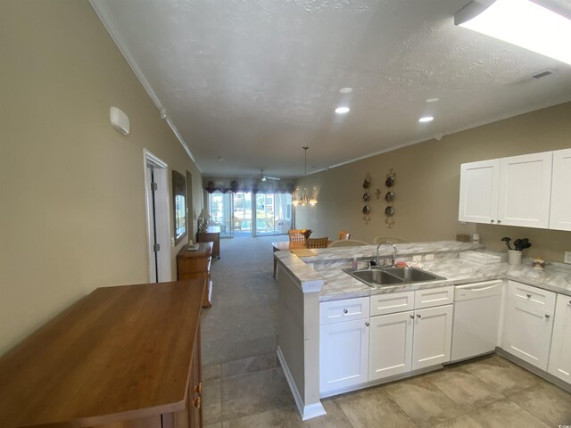 901-9 W Port Dr Unit 907, North Myrtle Beach, SC 29582 - kitchen featuring white dishwasher, a sink, ornamental molding, a peninsula, and white cabinets