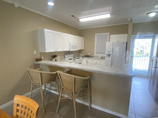 901-9 W Port Dr Unit 907, North Myrtle Beach, SC 29582 - kitchen with white appliances, a peninsula, light countertops, white cabinets, and ornamental molding