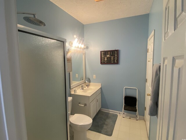 901-9 W Port Dr Unit 907, North Myrtle Beach, SC 29582 - bathroom featuring a shower stall, toilet, vanity, a textured ceiling, and baseboards