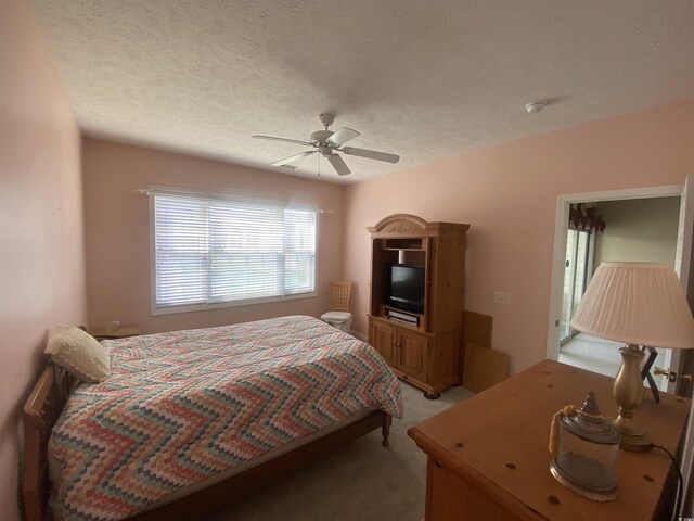 901-9 W Port Dr Unit 907, North Myrtle Beach, SC 29582 - bedroom featuring light carpet, a textured ceiling, and a ceiling fan