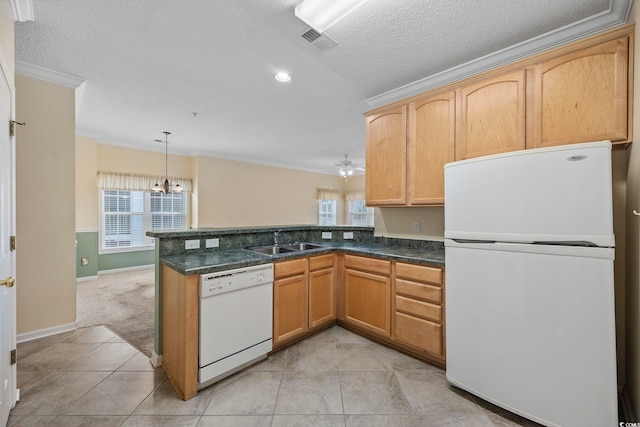 kitchen featuring ornamental molding, white appliances, a peninsula, visible vents, and a sink