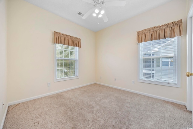 spare room with baseboards and carpet flooring