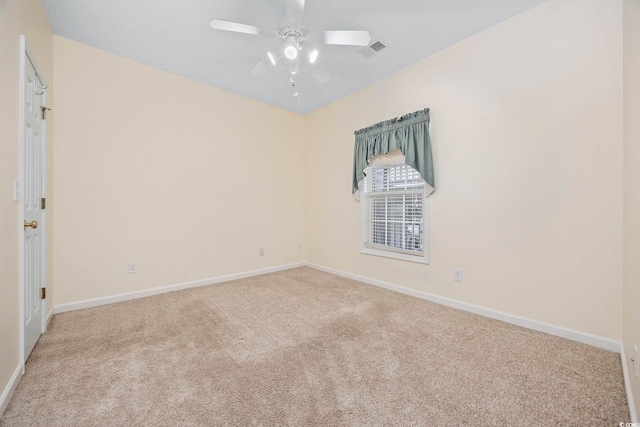 carpeted empty room featuring visible vents, ceiling fan, and baseboards