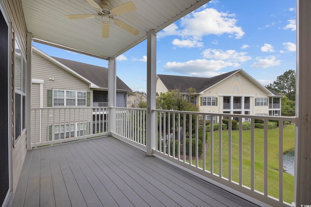 deck featuring a yard and ceiling fan