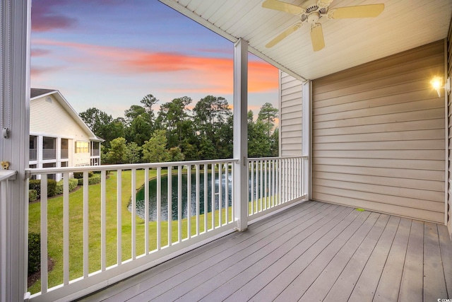 deck featuring ceiling fan and a lawn