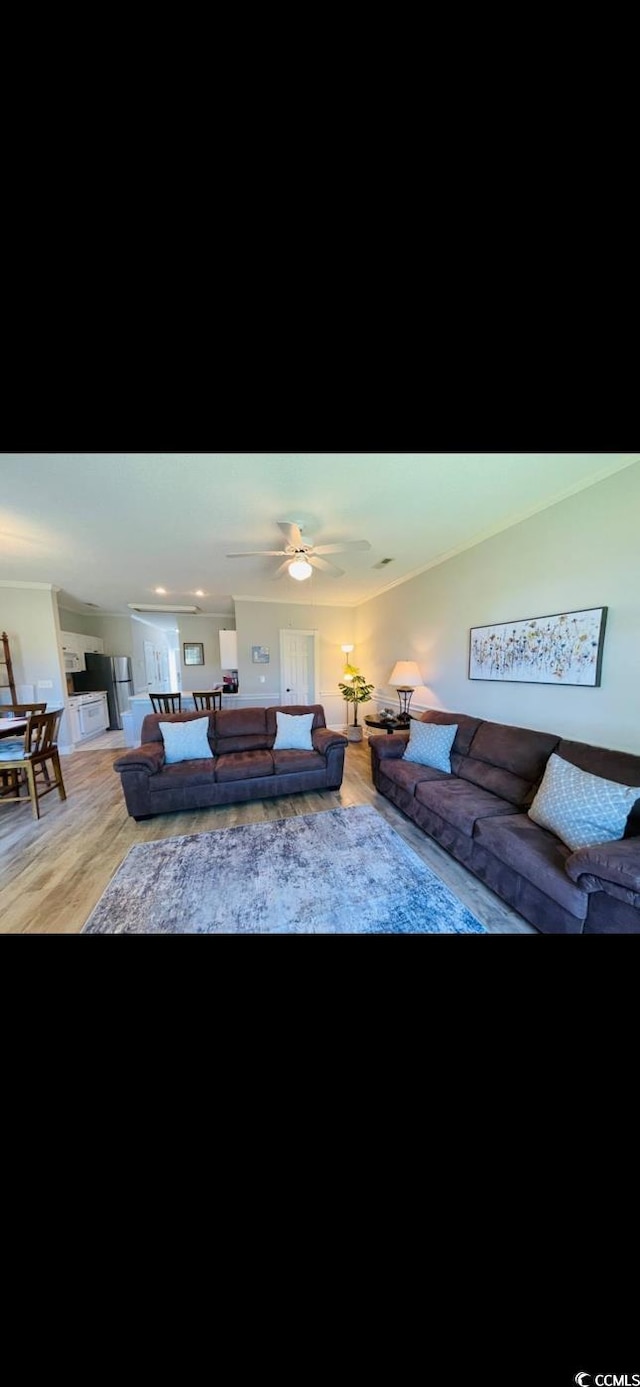 4669 Wild Iris Dr Unit 22-2O2, Myrtle Beach, SC 29577 - living room with a ceiling fan and light wood finished floors