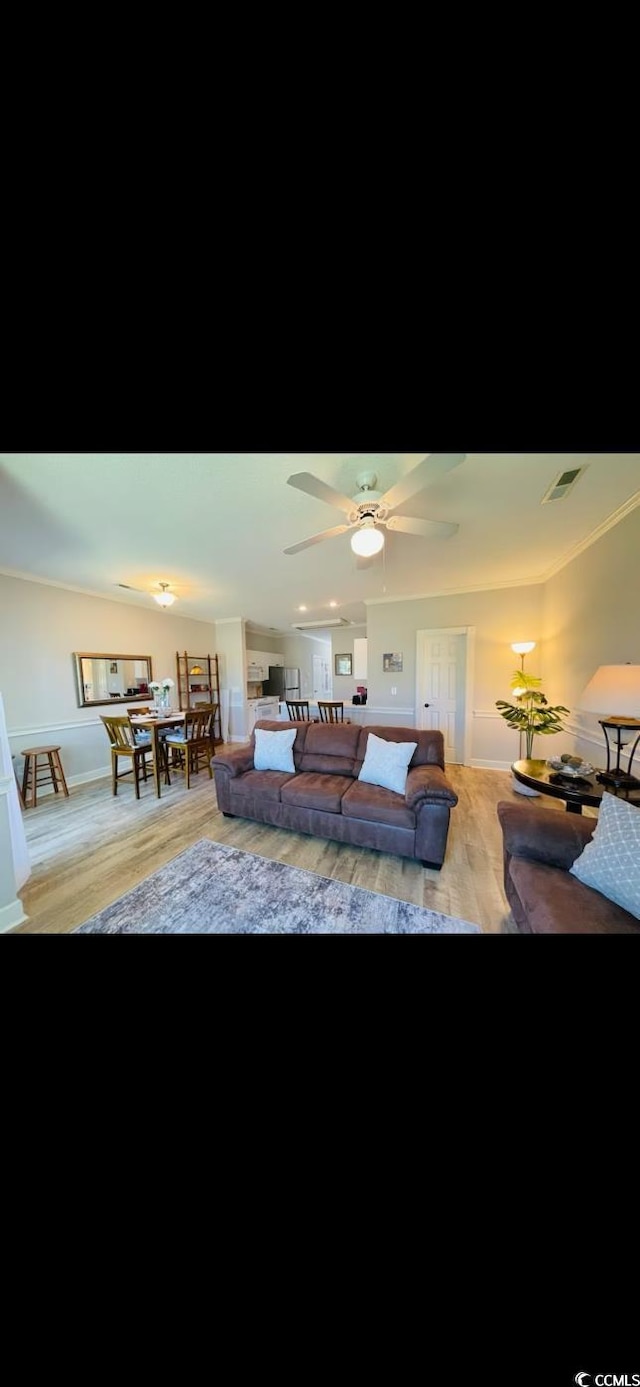 4669 Wild Iris Dr Unit 22-2O2, Myrtle Beach, SC 29577 - living room featuring visible vents, wood finished floors, and a ceiling fan