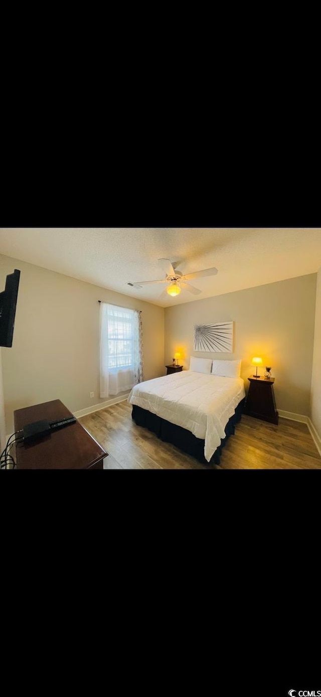 4669 Wild Iris Dr Unit 22-2O2, Myrtle Beach, SC 29577 - bedroom with baseboards, light wood-type flooring, and a ceiling fan
