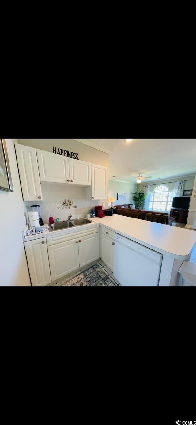 4669 Wild Iris Dr Unit 22-2O2, Myrtle Beach, SC 29577 - kitchen with light countertops, dishwasher, a sink, white cabinetry, and a peninsula