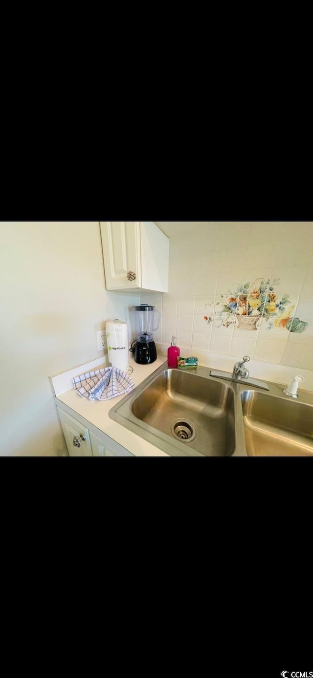 4669 Wild Iris Dr Unit 22-2O2, Myrtle Beach, SC 29577 - kitchen with white cabinetry, light countertops, and a sink