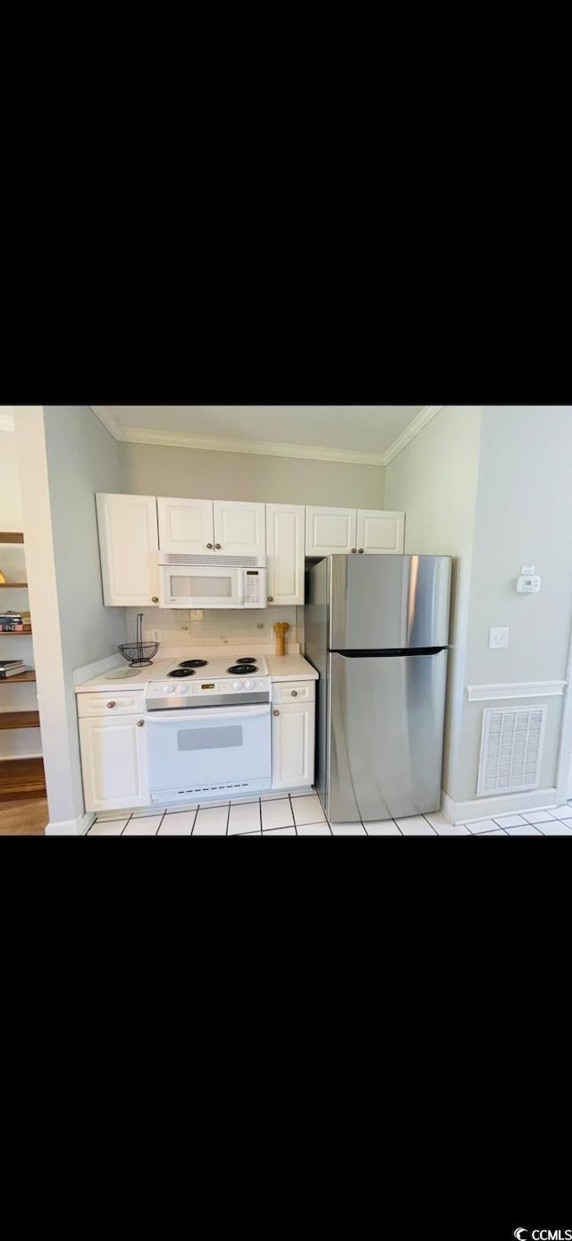 4669 Wild Iris Dr Unit 22-2O2, Myrtle Beach, SC 29577 - kitchen featuring visible vents, white appliances, ornamental molding, and white cabinets
