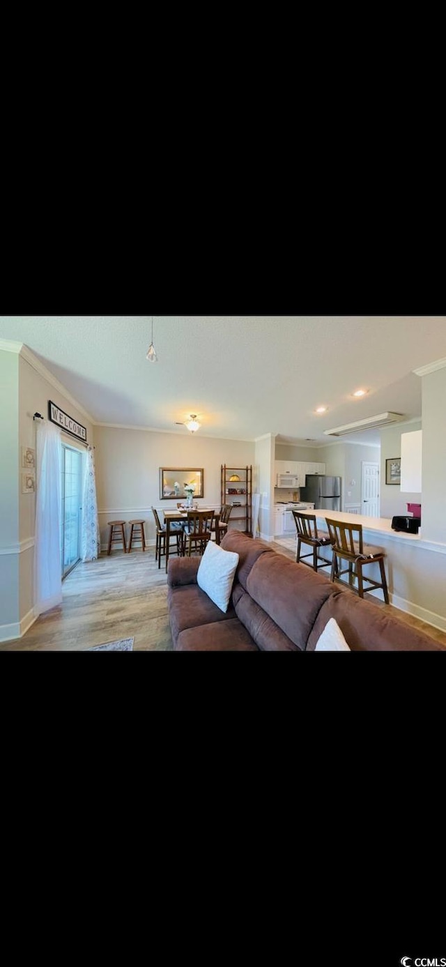 4669 Wild Iris Dr Unit 22-2O2, Myrtle Beach, SC 29577 - living room with baseboards, wood finished floors, and ornamental molding